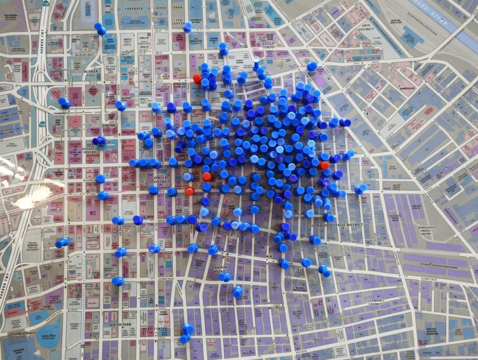 A map of downtown L.A. displays overdose reversals with blue pins while the red pins show overdose fatalities.