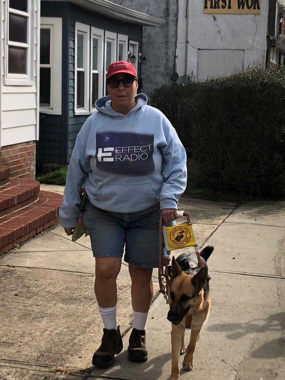 Angie Polizzotto and her service dog Molly walk through Keyport in 2022.