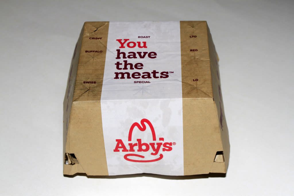 A box is photographed containing an Arby's sandwich. 
