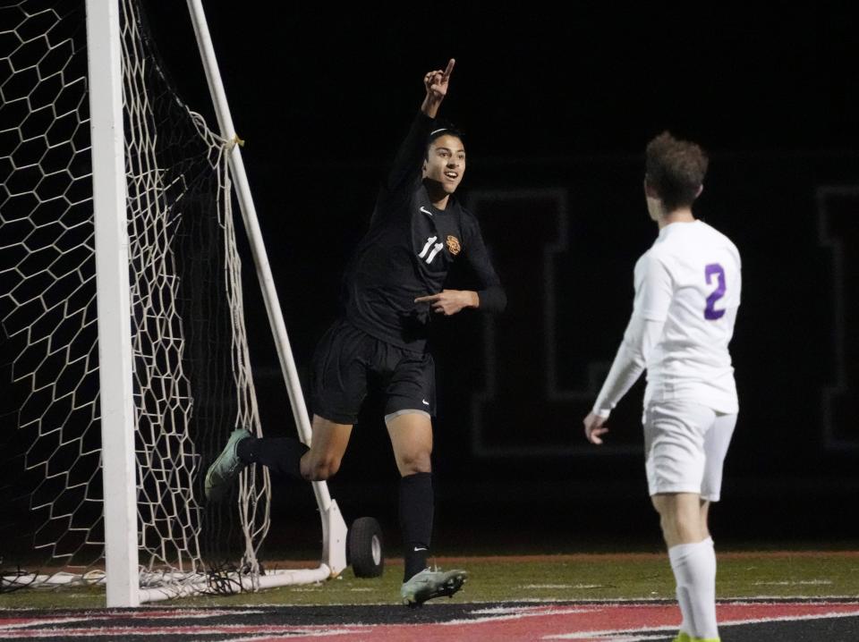 Feb 22, 2022; Gilbert, Arizona, U.S.;  Salpointe Catholic forward Sergio Ruiz De Chavez  celebrates after scoring as Notre Dame Prep defender Albert Aguirre watches during the State 4A boys soccer championship at Williams Field High School.