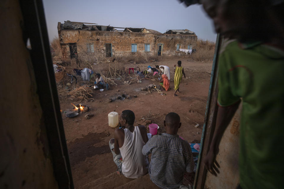 FILE - In this Dec. 12, 2020, file photo, Tigrayan refugees who fled Ethiopia's conflict, prepare to cook their dinners in front of their temporary shelters, at Umm Rakouba, a refugee camp in Qadarif, eastern Sudan. Huge unknowns persist in the deadly conflict, but details of the involvement of neighboring Eritrea, one of the world's most secretive countries, are emerging with witness accounts by survivors and others. (AP Photo/Nariman El-Mofty, File)