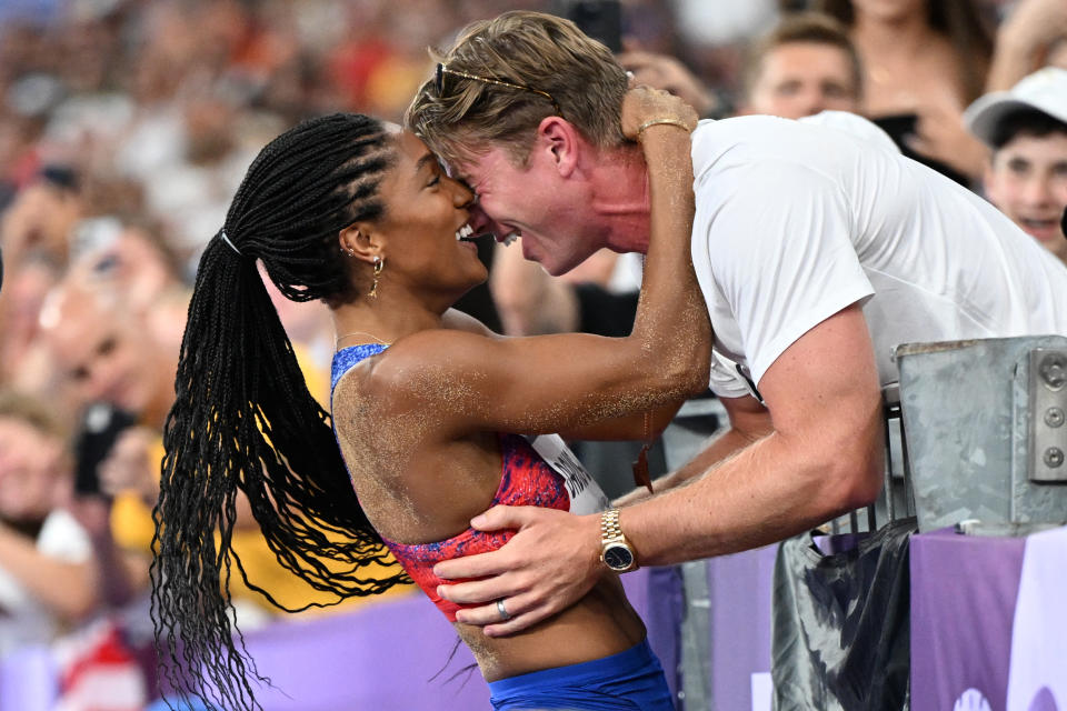 Tara Davis-Woodhall celebrates with her husband, Hunter Woodhall, after winning the women's long jump final at the 2024 Olympic Games. (Kirill Kudryavtsev/AFP via Getty Images)