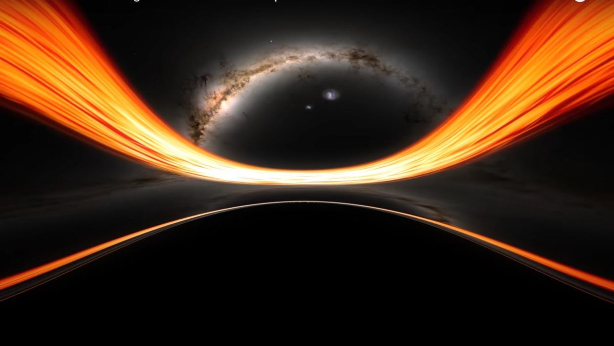  An artist's rending of the moment before falling into a black hole. You can see a starry galaxy and strips of bright light bending to the gravity of the black hole. 