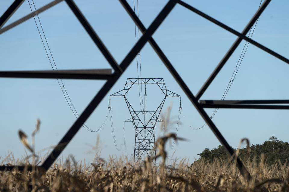 FILE - Electricity poles are seen in the countryside outside Lyon, central France, Sept. 12, 2022. Europe's sky-high natural gas prices have fallen thanks to unseasonably warm weather and efforts to fill up storage ahead of winter. Prices have fallen to their lowest level since June and electricity is cheaper, too. Lower use by industry has helped to reduce demand for fuel as well. (AP Photo/Laurent Cipriani, file)