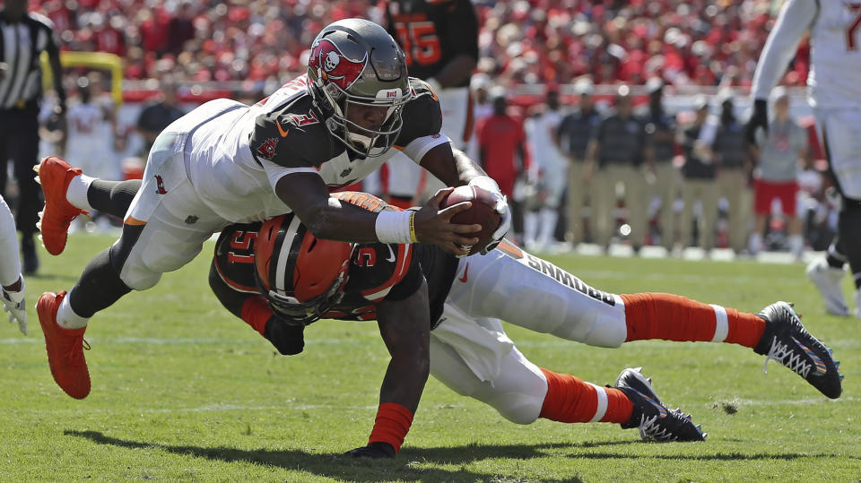 Tampa Bay Buccaneers quarterback Jameis Winston (3) dives over Cleveland Browns outside linebacker Jamie Collins (51) on a 14-yard touchdown run during the first half of an NFL football game Sunday, Oct. 21, 2018, in Tampa, Fla. (AP Photo/Mark LoMoglio)