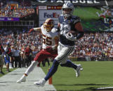 Dallas Cowboys tight end Jason Witten (82) scores a touchdown against Washington Redskins linebacker Cole Holcomb (55) in the first half of an NFL football game, Sunday, Sept. 15, 2019, in Landover, Md. (AP Photo/Evan Vucci)