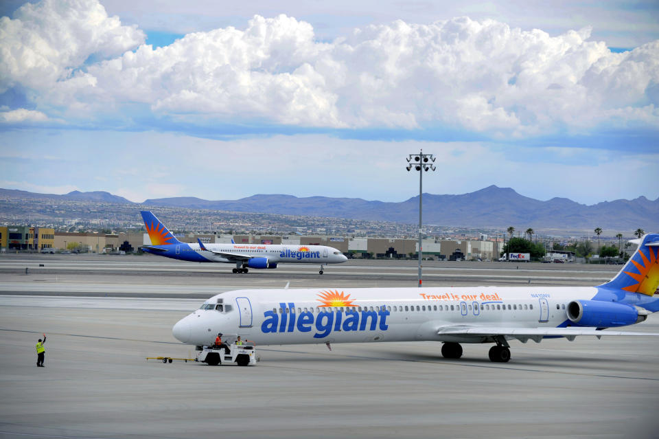 In this Thursday, May 9, 2013, photo, two Allegiant Air jets taxi at McCarran International Airport in Las Vegas. While other U.S. airlines have struggled with the ups and downs of the economy and oil prices, tiny Allegiant Air has been profitable for 10 straight years. (AP Photo/David Becker)