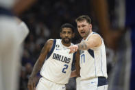 Dallas Mavericks guard Kyrie Irving (2) listens to guard Luka Doncic (77) in the first quarter of an NBA basketball game against the Sacramento Kings in Sacramento, Calif., Saturday, Feb. 11, 2023. (AP Photo/José Luis Villegas)