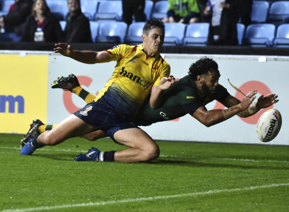 Australia's Josh Addo-Carr, right, scores a try during the Rugby League World Cup match between Australia and Scotland at Coventry Building Society Arena, Coventry, England, Friday, Oct. 21, 2022. (AP Photo/Rui Vieira)