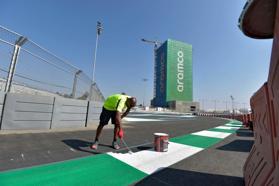 Workers put the final lick of paint on the Jeddah Corniche Circuit (AFP via Getty Images)