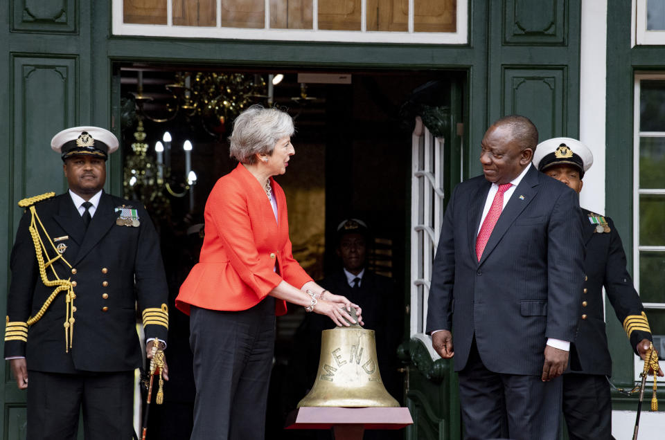 In this photo taken Aug. 28 2018, British Prime Minister, Theresa May, left, hands over the brass bell of the SS Mendi to South African President Cyril Ramaphosa, right in Cape Town, South Africa. Amid the fanfare marking the 100th anniversary of the end of World War I, little has been said about some crucial participants in the conflict: Africans. More than 1 million African soldiers, laborers and porters were vital actors in the war in Europe and especially in battles on the African continent, yet little commemorates their role. The SS Mendi was carrying black South Africans from England to France on a foggy night in Feb 1017 when it was struck by a British mail ship causing it to sink, killing 607 African men on board. (AP Photo).