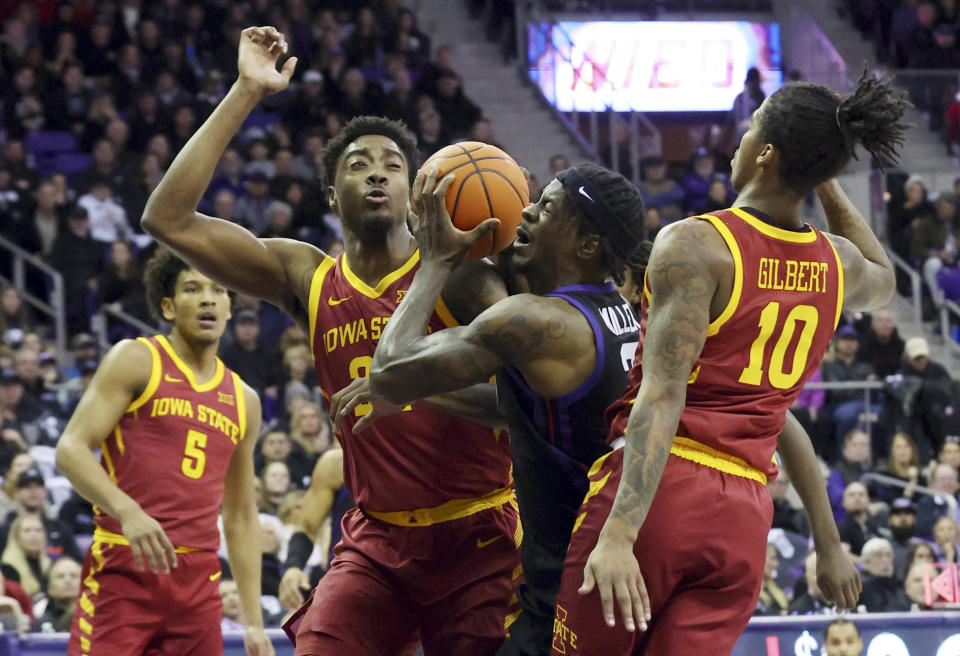 TCU forward Emanuel Miller (2) tries to shoot between Iowa State guard Keshon Gilbert (10) and forward Hason Ward (24) in the first half of an NCAA basketball game Saturday, Jan. 20, 2024, in Fort Worth, Texas. (AP Photo/Richard W. Rodriguez)