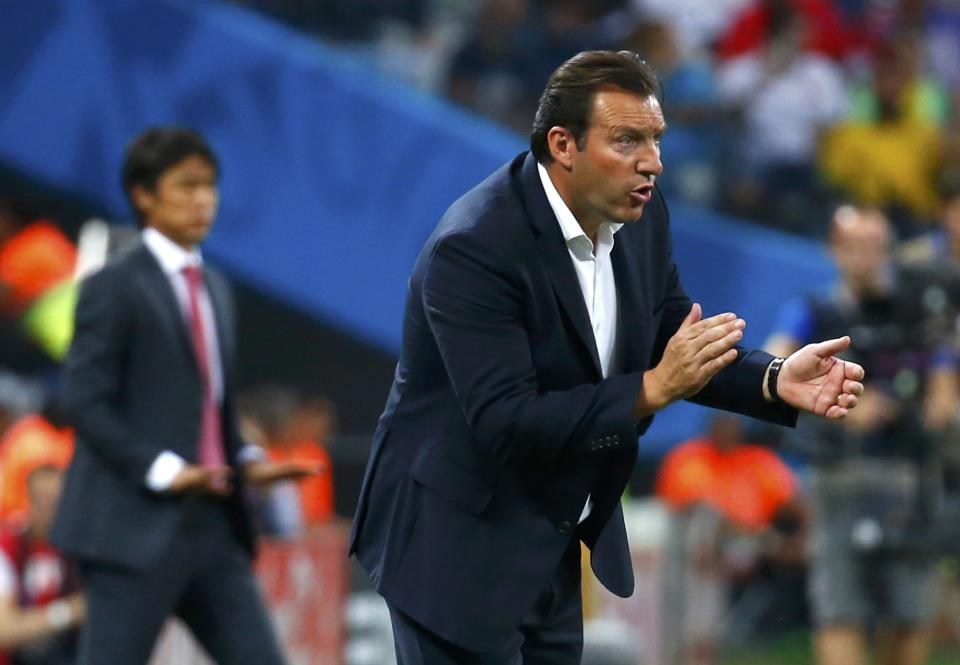 Belgium's coach Marc Wilmots watches with South Korea's coach Hong Myung-bo during their 2014 World Cup Group H soccer match at the Corinthians arena in Sao Paulo