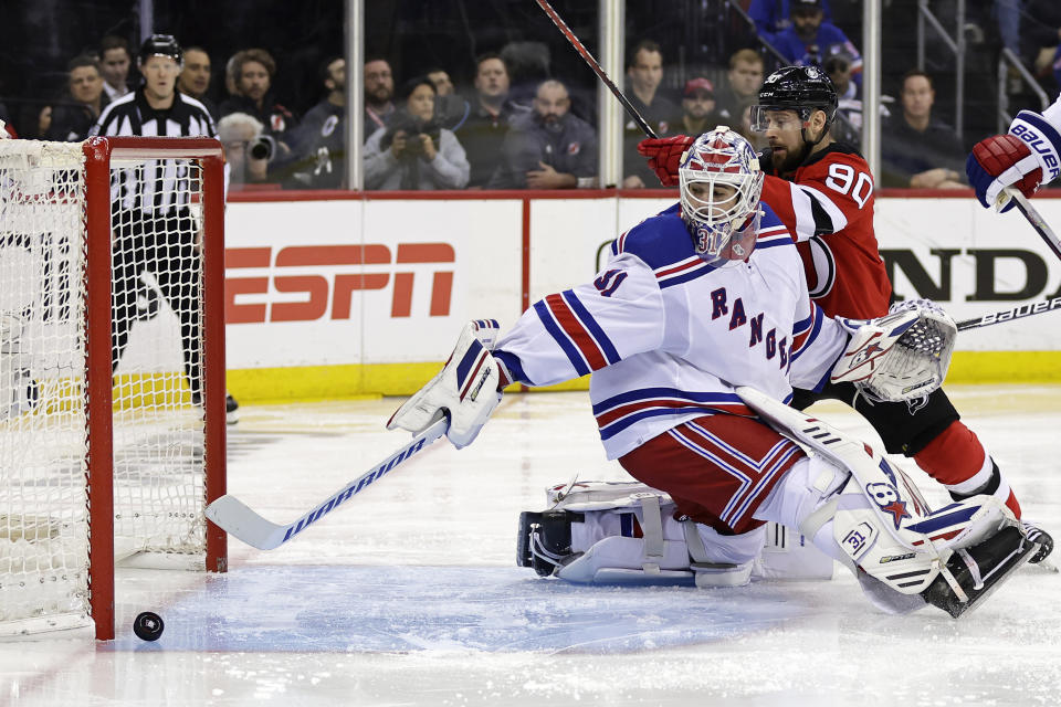 New York Rangers goaltender Igor Shesterkin (31) watches a shot go wide in front of New Jersey Devils left wing Tomas Tatar (90) during the second period of Game 7 of an NHL hockey Stanley Cup first-round playoff series Monday, May 1, 2023, in Newark, N.J. (AP Photo/Adam Hunger)