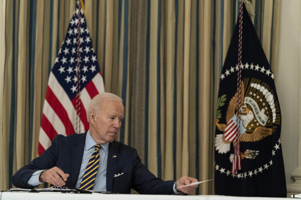 President Joe Biden passes a note to Secretary of State Antony Blinken, during a virtual meeting with Indian Prime Minister Narendra Modi, Australian Prime Minister Scott Morrison and Japanese Prime Minister Yoshihide Suga, from the State Dining Room of the White House, Friday, March 12, 2021, in Washington. (AP Photo/Alex Brandon)