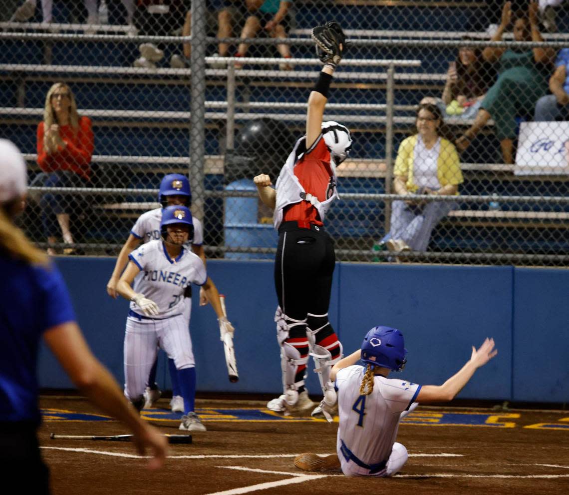 Boswell’s Audrey Tullis scores as the throw to Trinity catcher Phoebe Smyers (8) went high during a high school softball game at Boswell High School in Saginaw, Texas, April 16, 2024.