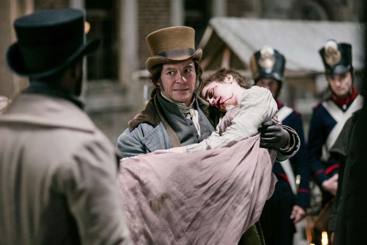 David Oyelowo (back to camera), Dominic West and Lily Collins in Les Miserables. (©PBS / Courtesy Everett Collection)