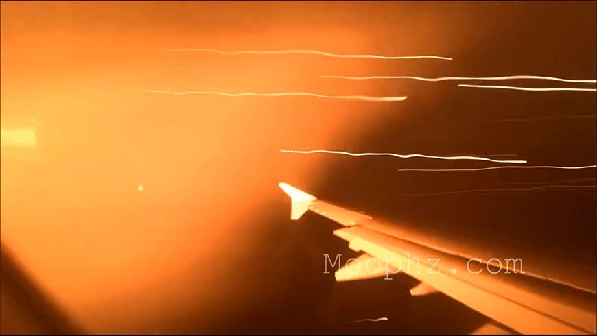 A passenger captures flames shooting from a plane engine. Photo: Youtube/Moophz.com