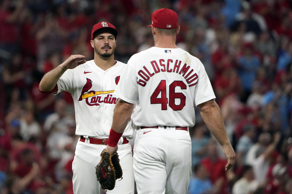 St. Louis Cardinals' Nolan Arenado and Paul Goldschmidt (46) celebrate a 3-1 victory over the Milwaukee Brewers following a baseball game Friday, Aug. 12, 2022, in St. Louis. (AP Photo/Jeff Roberson)