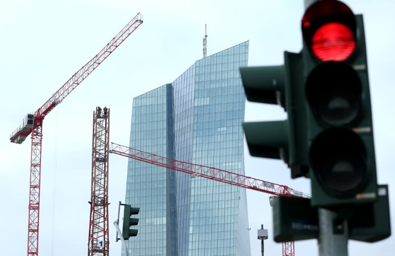 FILE PHOTO: Specialists work on a crane in front of the European Central Bank (ECB) in Frankfurt