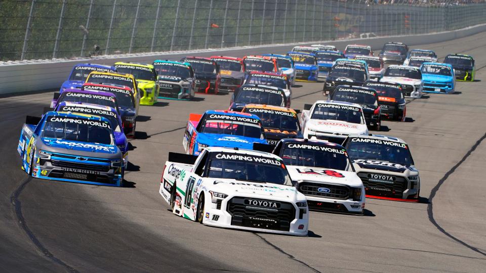 Chandler Smith (18) leads the pack down the front straight on a restart of the NASCAR Truck Series auto race at Pocono Raceway, Saturday, July 23, 2022 in Long Pond, Pa. (AP Photo/Matt Slocum)