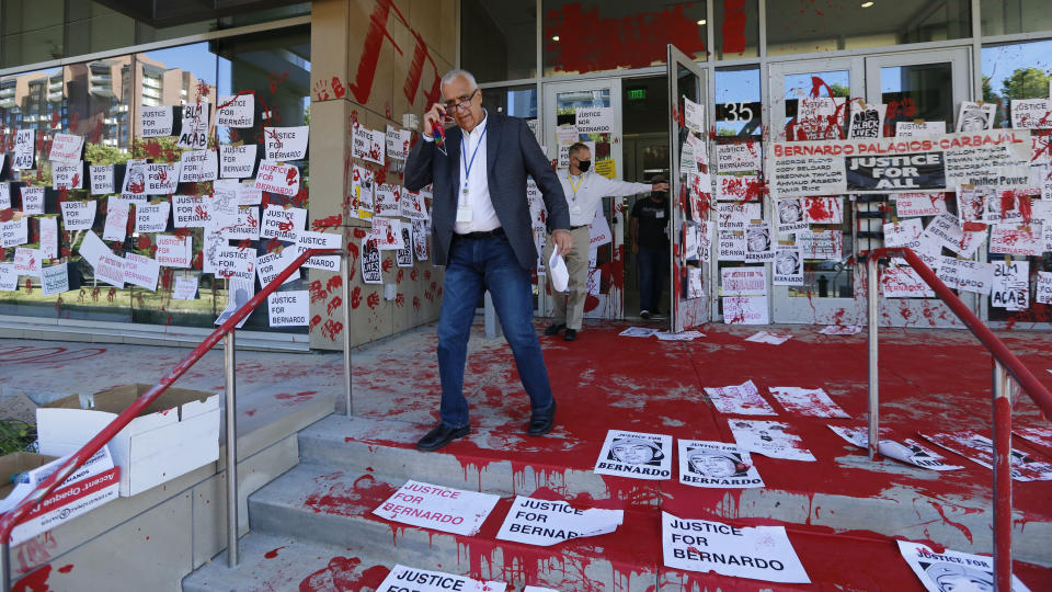 FILE - In this July 10, 2020, file photo, District Attorney Sim Gill inspects the damage to the district attorney's office in Salt Lake City. Some Black Lives Matter protesters in Utah could face up to life in prison if they're convicted of splashing red paint and smashing windows during a protest, a potential punishment that stands out among demonstrators arrested around the country and one that critics say doesn't fit the alleged crime. (AP Photo/Rick Bowmer, File)