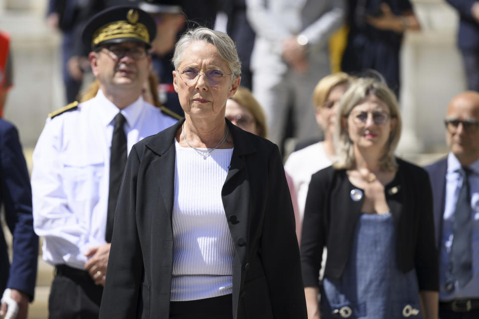 French Prime Minister Elisabeth Borne, front, leaves the Haute Savoie prefecture in Annecy, French Alps, Thursday, June 8, 2023. An attacker with a knife stabbed several young children and at least one adult, leaving some with life-threatening injuries, in a town in the Alps on Thursday before he was arrested, authorities said. (Jean-Christophe Bott/Keystone via AP)