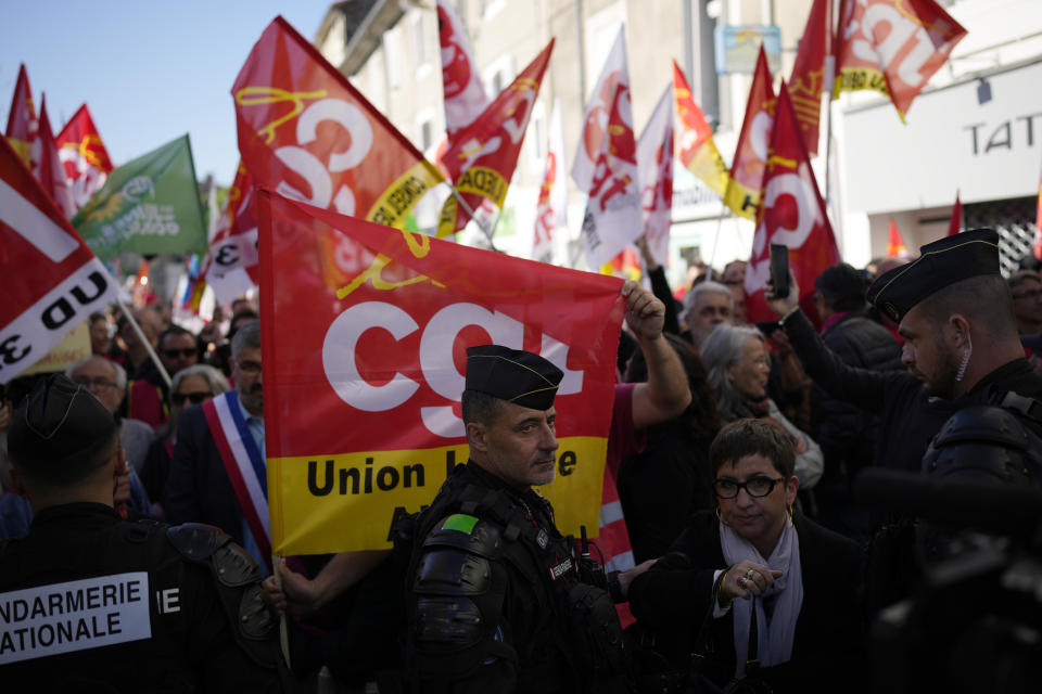 People demonstrate before French President Emmanuel Macron's visit, Thursday, April 20, 2023 in Ganges, southern France. The French leader tries to repair damage done to his presidency by forcing through unpopular pension reforms. Raising the retirement age from 62 to 64 has ignited a months-long firestorm of protest in France. (AP Photo/Daniel Cole)