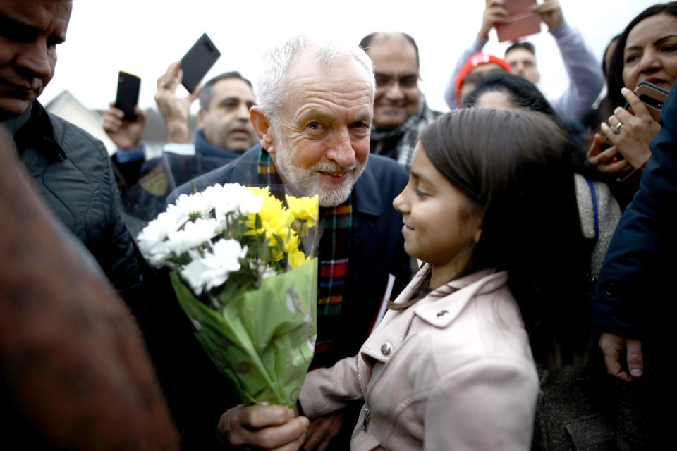 Labour Party leader Jeremy Corbyn holds some flowers as he meets supporters during a visit to Thurrock in Essex whilst on the General Election campaign trail.