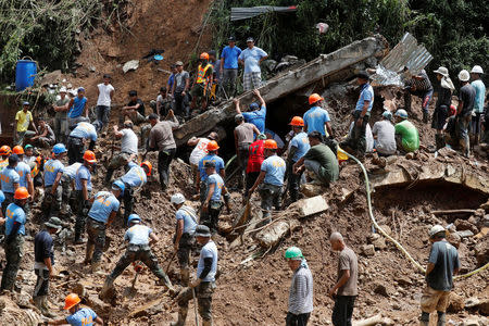 Rescuers search for people trapped in a landslide, after super typhoon Mangkhut hit the country, at a mining camp in Itogon, Benguet, Philippines September 17, 2018. REUTERS/Erik De Castro