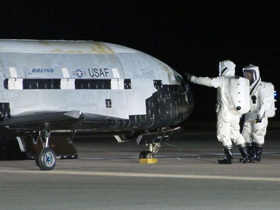 Technicians examining the X-37B unmanned spaceplane at Vandenberg Air Force Base, California (AP)