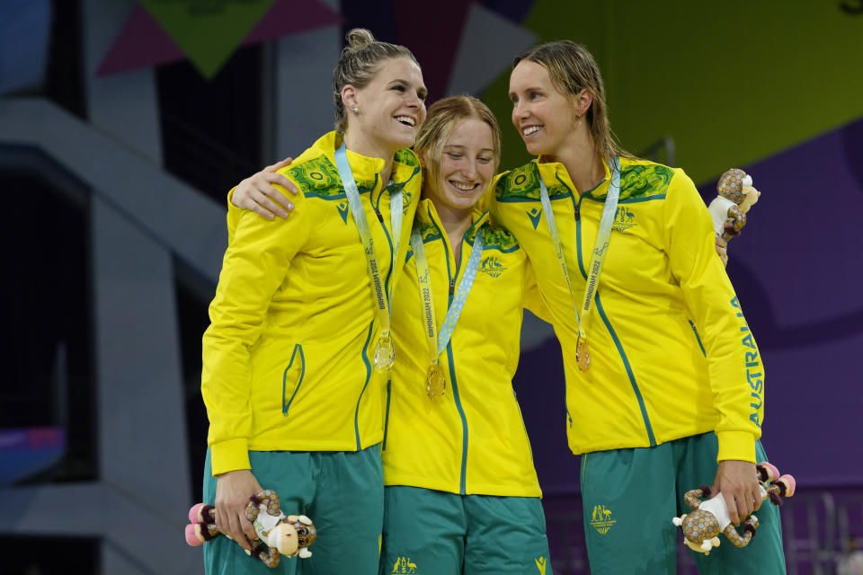 Australia's gold medalist Mollie O'Callaghan, centre, silver medalist Shayna Jack, left, and bronze medalist Emma McKeon celebrate during a medal ceremony for the Women's 100m Freestyle Final of the swimming competition at the Commonwealth Games, at the Sandwell Aquatics Centre in Birmingham, England, Tuesday, Aug. 2, 2022. (AP Photo/Kirsty Wigglesworth)