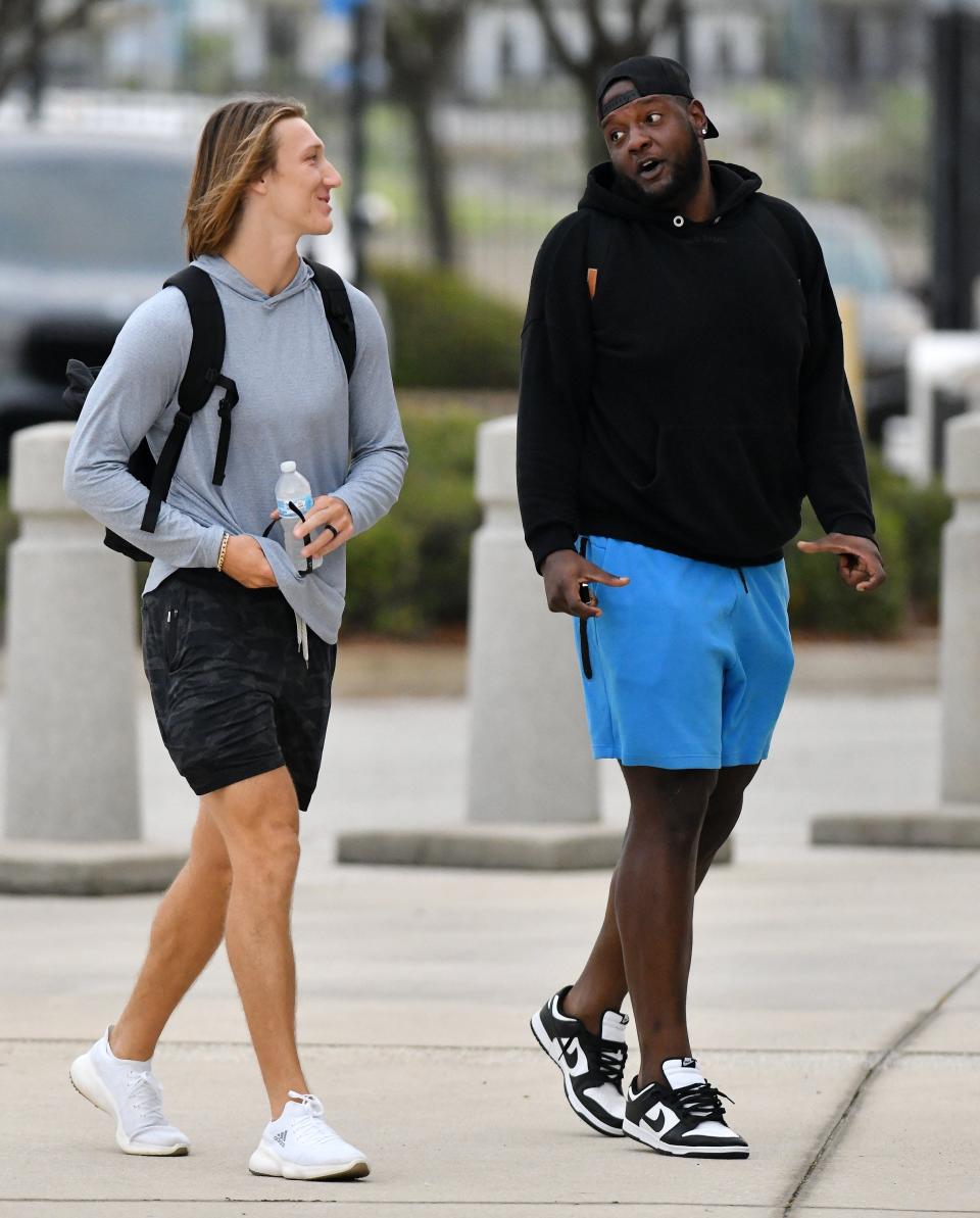 Jaguars rookie quarterback, (16) Trevor Lawrence walks into TIAA Bank Field with veteran OL, (74) Cam Robinson as the veteran players officially reported to training camp Tuesday morning. The Jacksonville Jaguars veteran players joined the rookies for this weeks start of training camp early Tuesday morning, July 27, 2021 at TIAA Bank Field. [Bob Self/Florida Times-Union]