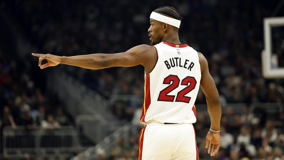 Miami Heat forward Jimmy Butler (22) signals against the Milwaukee Bucks during the first half of Game 5 in a first-round of an NBA basketball playoff series Wednesday, April 26, 2023, in Milwaukee. (AP Photo/Jeffrey Phelps)