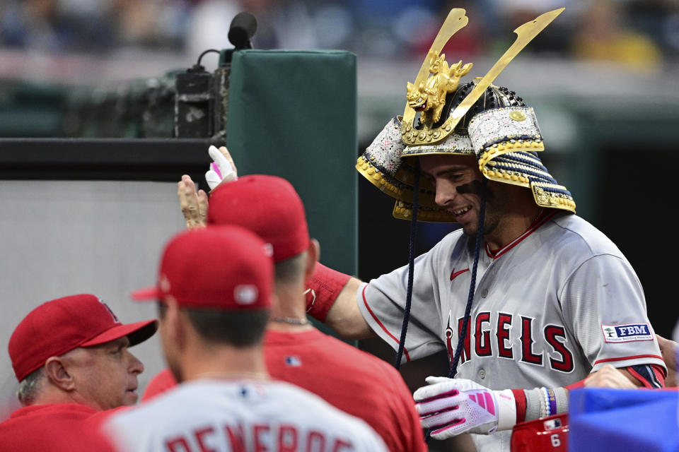 Los Angeles Angels' Zach Neto is congratulated while entering the dugout after hitting a two-run home run off Cleveland Guardians relief pitcher Eli Morgan during the eighth inning of a baseball game Saturday, May 13, 2023, in Cleveland. The Guardians won 8-6. (AP Photo/David Dermer)