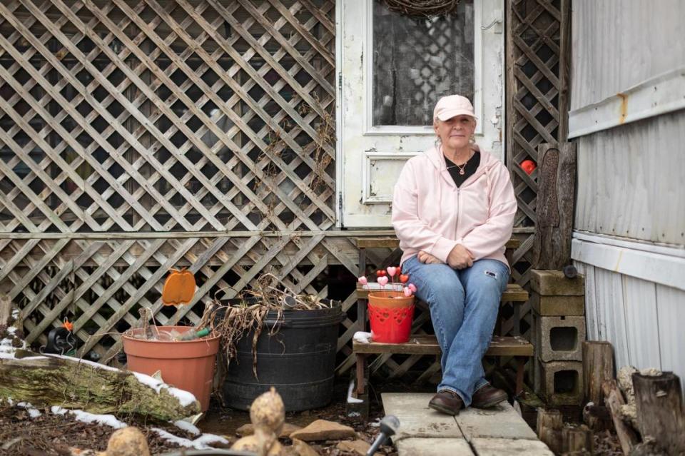 Mindy Davenport poses for a portrait outside her trailer at the North Fork Moblie Home Park in Morehead.