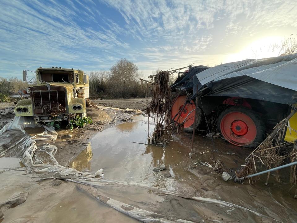 A flooded tractor sits next to a decommissioned truck amid washed out strawberry fields near Ventura on Jan. 10. Ventura County saw its wettest years in ages in 2023, starting with a devastating storm in January.