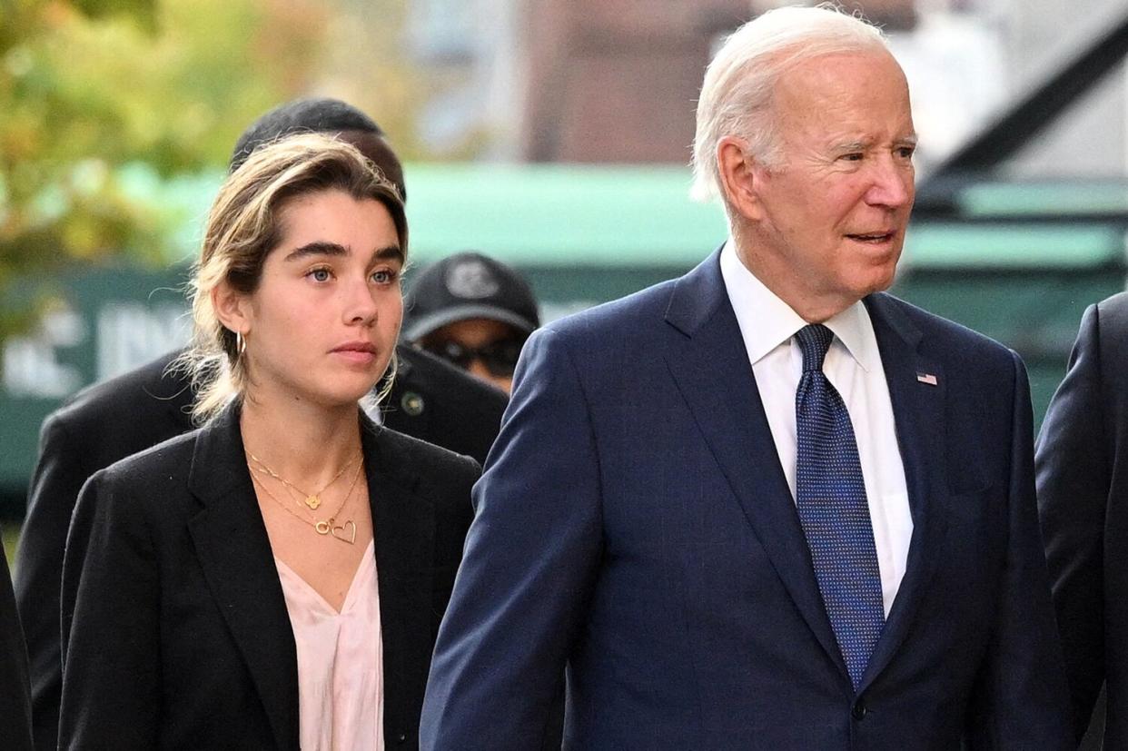 US President Joe Biden (R) walks to the University of Pennsylvania bookstore with granddaughter Natalie Biden during a visit to the campus in Philadelphia on October 7, 2022.