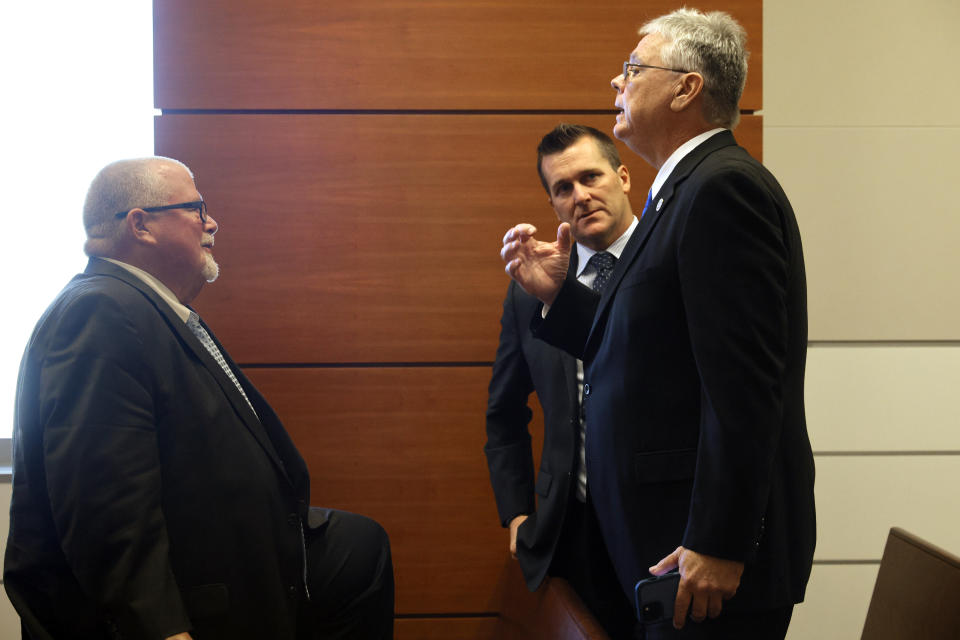 Former Marjory Stoneman Douglas High School School Resource Officer Scot Peterson, right, speaks with his attorney, Michael Piper, during a break in a hearing regarding the MSD civil case at the Broward County Courthouse in Fort Lauderdale, Fla., Monday, Dec. 18, 2023. (Amy Beth Bennett/South Florida Sun-Sentinel via AP, Pool)