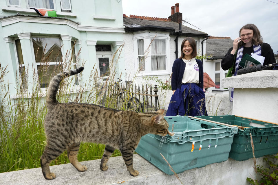 Councillor Raphael Hill, right, speaks to resident Emma Jade Larsson as they canvass for The Green Party in the Round Hill Ward in Brighton, East Sussex, England, Wednesday, June 12, 2024. There’s lots of talk of change in Britain’s election campaign, but little talk about climate change. The U.K.’s July 4 vote to choose a new government comes after one of the wettest and warmest winters on record, part of trends scientists attribute to global warming. (AP Photo/Kirsty Wigglesworth)