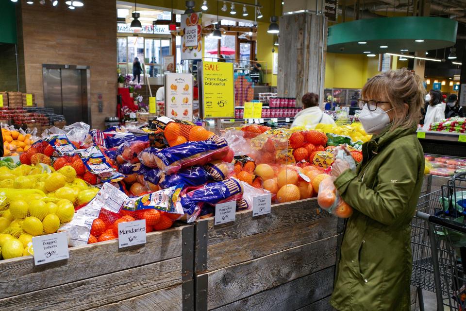 A shopper bags fruit inside a supermarket in Chevy Chase, Maryland on February 17, 2022. - US retail sales boomed in January as shops more than regained ground lost in an unexpected December slump, despite high inflation, according to government data released February 16. Retail sales rose 3.8 percent last month, the Commerce Department said, double what was expected and a dramatic reversal of the 2.5 percent decline in December, which was worse than originally reported. (Photo by MANDEL NGAN / AFP) (Photo by MANDEL NGAN/AFP via Getty Images)