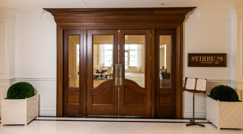 The entrance to Stirrups Restaurant inside The Equine Hotel.