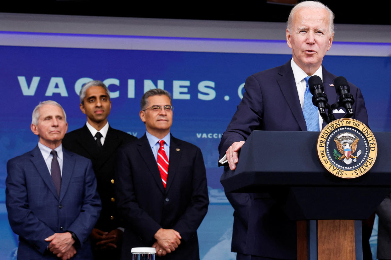 From left, Dr. Anthony Fauci, Surgeon General Vivek Murthy and Health and Human Services Secretary Xavier Becerra look on as Biden delivers remarks on COVID vaccinations.