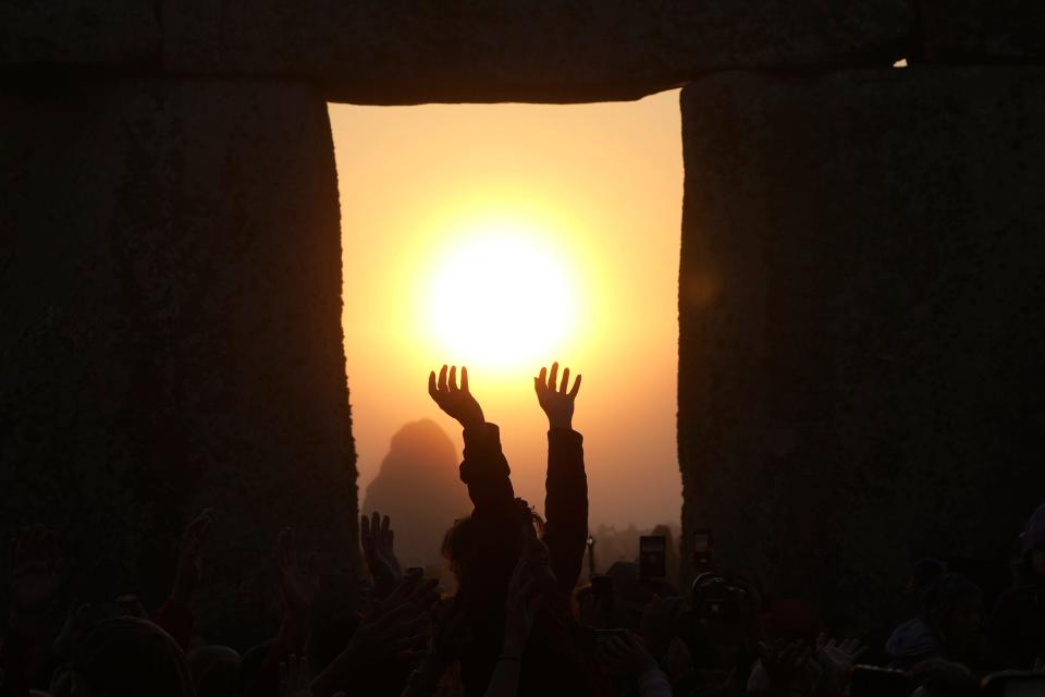 Revellers gather at the ancient stone circle Stonehenge to celebrate the Summer Solstice.