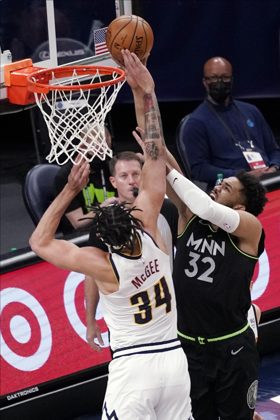 Denver Nuggets' JaVale McGee (34) breaks up a layup attempt by Minnesota Timberwolves' Karl-Anthony Towns (32) during the first half of an NBA basketball game Thursday, May 13, 2021, in Minneapolis. (AP Photo/Jim Mone)