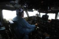 Caption Dinh Van Qua operates on the cockpit of an aircraft AN-26 belonging to the Vietnam Air Force during a search and rescue mission off Vietnam's Tho Chu island March 10, 2014. REUTERS/Kham