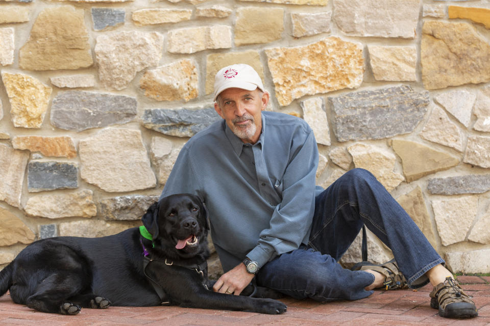 Philip Tedeschi, director emeritus of the Institute for Human-Animal Connection at the University of Denver, poses with his dog, Samara, on campus in Denver on July 25, 2018. In the eyes of the law, pets are property when it comes to divorce. But new ways of working out custody of the dog, cat or parrot have sprung up in recent years. There are special mediators and a push for “petnups” to avoid courtroom disputes. (Jess Blackwell Photography/Rover.com via AP).