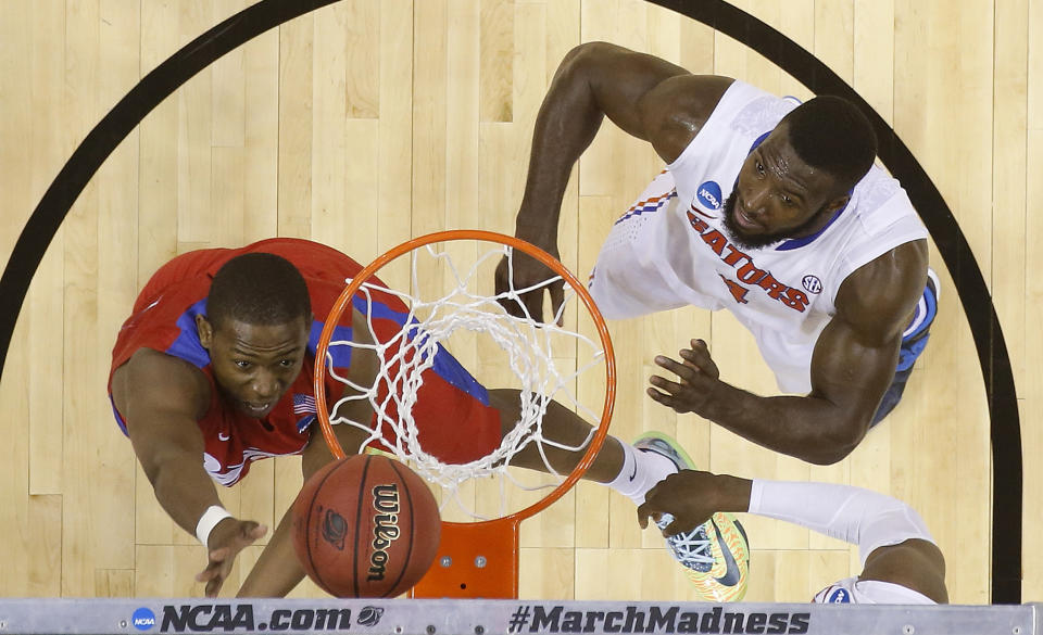 Dayton forward Kendall Pollard (22) shoots against Florida center Patric Young (4) during the second half in a regional final game at the NCAA college basketball tournament, Saturday, March 29, 2014, in Memphis, Tenn. Florida won 62-52. (AP Photo/John Bazemore)