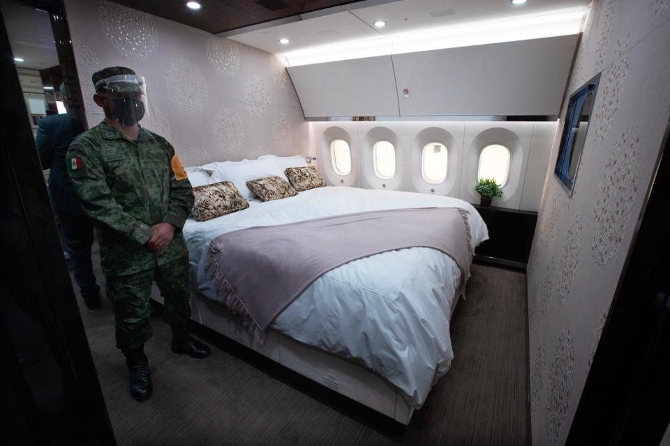 The private suite with a guard standing next to a king-sized bed onboard the former Mexican VIP Boeing 787.