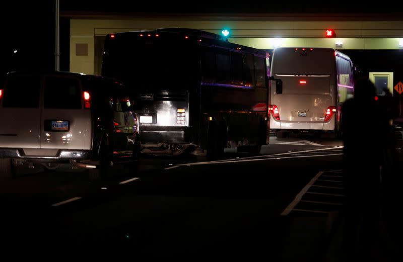 Buses carrying quarantined passengers fron the Grand Princess cruise ship drives onto Travis Air Force Base in Fairfield